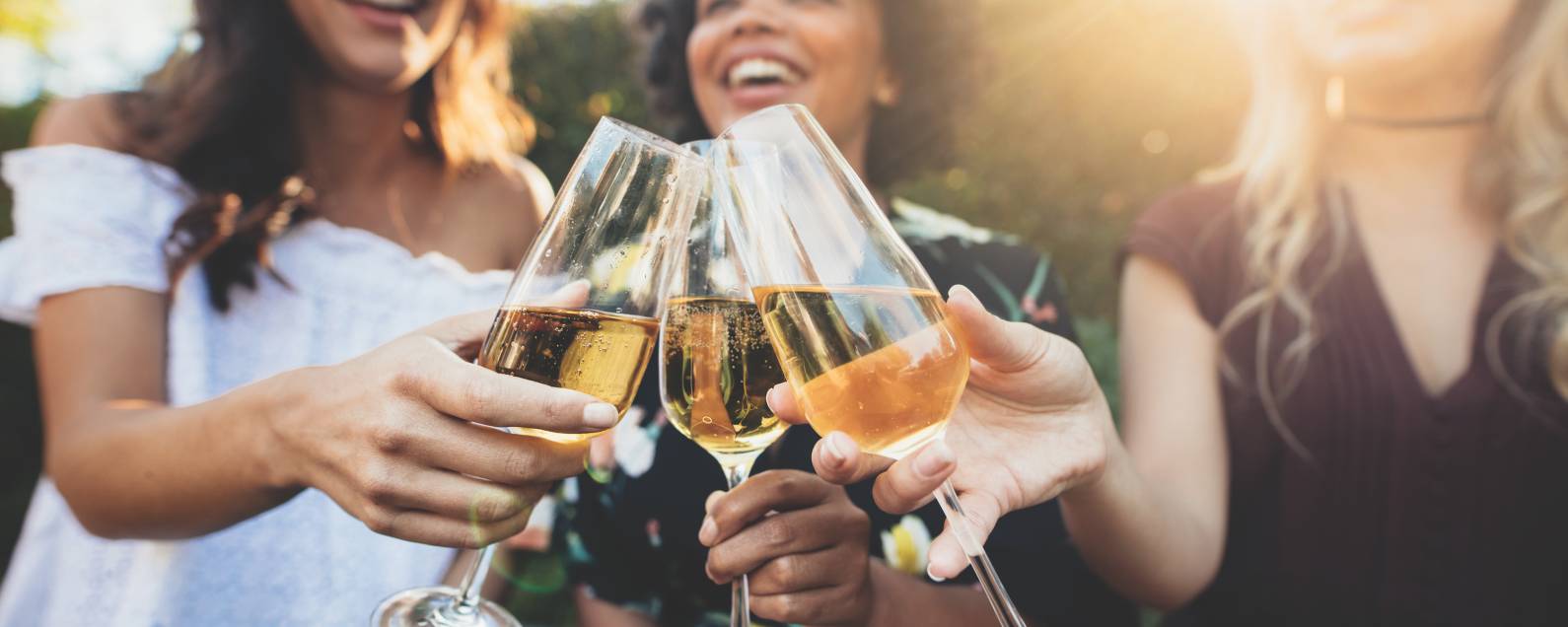 Young women cheers with champagne flutes.